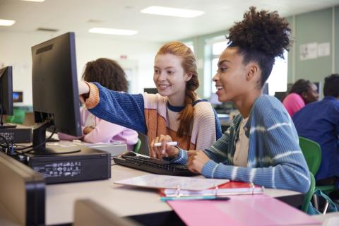 two female students in front of a computer